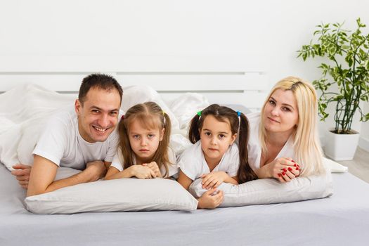 A young family with young children to bed in the bedroom.