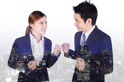 double exposure of successful business man and woman with arm raised with a city background