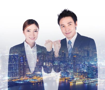 double exposure of successful business man and woman with arm raised with a city background