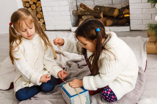 Two little girls in Christmas background.
