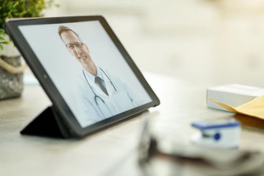 Copy-space photo of a professional medic in lab coat appearing on tablet screen