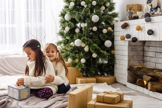 two little girls Sharing a Surprise on Christmas Morning.
