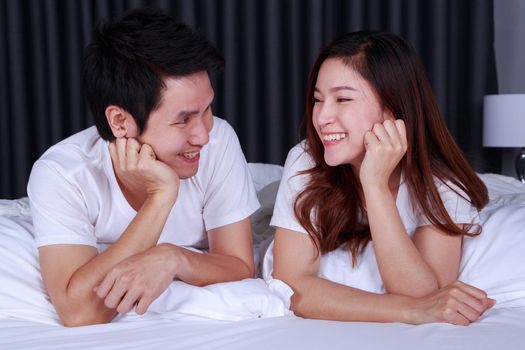 happy young couple on bed in the bedroom