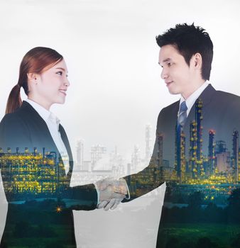 double exposure of shaking hand between businessman and businesswoman with industrial oil refinery plant background