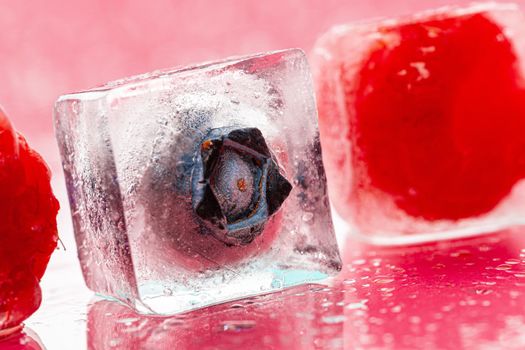 Ice cubes with berry for summer cocktails. High quality photo