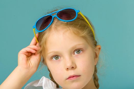 Fashionable little girl in sunglasses. The concept of outdoor recreation, tourism. Isolated.