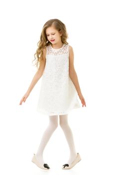 Full Body Length Portrait of Pretty Girl Wearing Beautiful White Lace Dress Posing in Studio, Girl with Blonde Long Hair Standing on Toes Slightly Crouching Her Knees on Isolated White Background