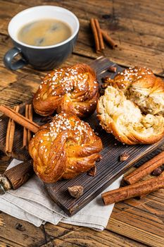 Breakfast with Cinnamon buns or rolls, Swedish Kanelbullar. wooden background. Top view.