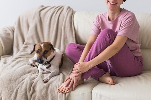 Young beautiful woman at home with her cute dog