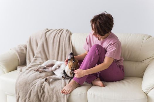 Young beautiful woman at home with her cute dog