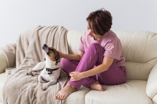 Young beautiful woman at home with her cute dog