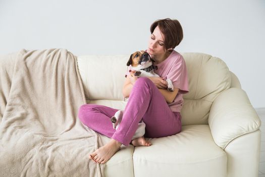 Young beautiful woman at home with her cute dog