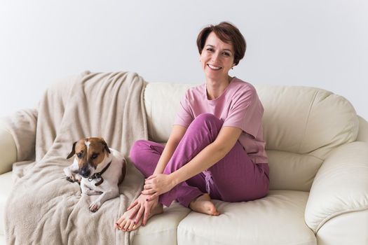 Young beautiful woman at home with her cute dog