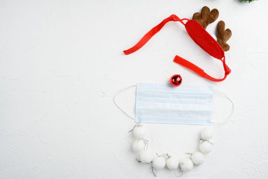 Christmas face from decorations and mask set and deer, on white stone table background, top view flat lay, with copy space for text