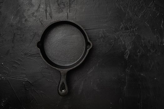 Empty skillet, frying pan set with copy space for text or food with copy space for text or food, top view flat lay, on black dark stone table background