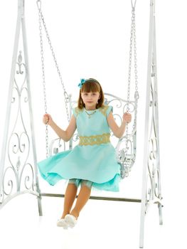 School-age teenage girl swinging on a swing. The concept of rest after class. Isolated on white background.