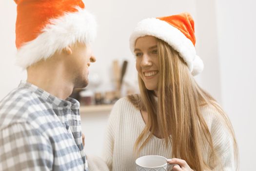 Young festive couple spending time togather in room, close up