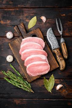 Sliced raw pork meat set, on old dark wooden table background, top view flat lay