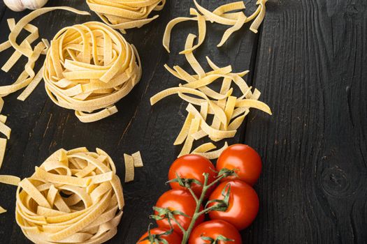 Pasta ingredients Tagliatelle with Italian food ingredients set, on black wooden table background, with copy space for text