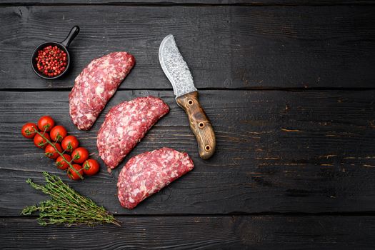 Raw minced beef patties set, on old dark wooden table background, top view flat lay, with copy space for text