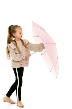 Beautiful little girl with umbrella. Concept of weather, climate change. Isolated on white background