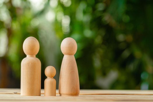 Wooden little figures of people close up. Family concept