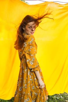 woman in dress posing nature yellow cloth fresh air. High quality photo