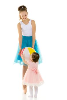 Graceful Ballerina Playing Ball with Adorable Smiling Toddler Girl, Teenage Girl in Blue Skirt, Leotard and Ballet Shoes Standing on Toes, Lovely Children Having Fun on Isolated on White Background
