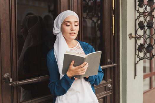 Young muslim girl wears hijab with diary book. Islamic student and knowledge concept
