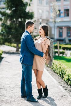 guy and a girl happily walk in the morning on the empty streets of old Europe