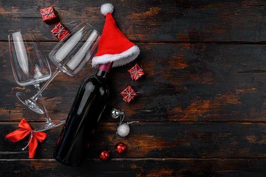 Christmas wine with New Year tree decor set, on old dark wooden table background, top view flat lay, with copy space for text