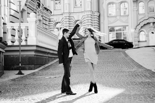 guy and a girl happily walk in the morning on the empty streets of old Europe