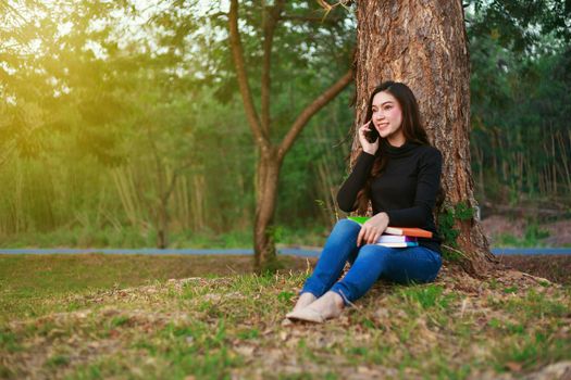 smiling woman talking on mobile phone in the park