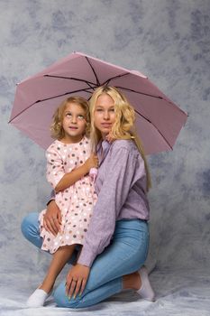 Beautiful young girl hugging her little sister. The concept of a happy childhood, family values.