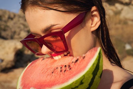 Cheerful woman eating watermelon nature summer vacation. High quality photo