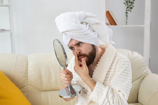Bearded man checking his skin of face. Spa, body and skin care for male