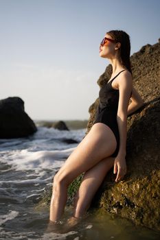 woman in a black swimsuit on the beach sea Summer vacation. High quality photo