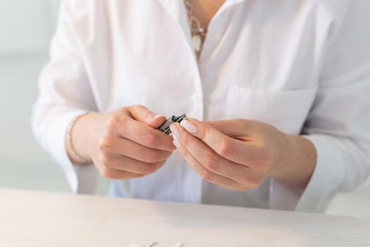 Professional jewelry designer making handmade jewelry in studio workshop. Fashion, creativity and handmade concept.