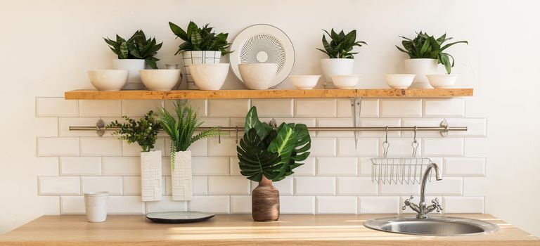 Home interior of a trendy, stylish, bright Scandinavian-style kitchen with open shelves. Loft interior.