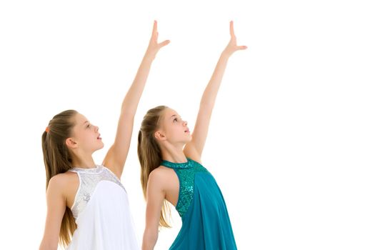 Pretty Gymnasts Performing Rhythmic Gymnastics Exercise Holding Each Other Hand and Raising it over their Head, Two Sisters Wearing Sport Dresses Dancing in Studio Against White Background