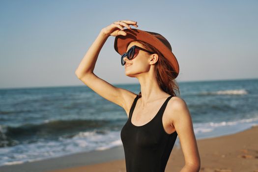 woman in a hat sunglasses by the ocean travel sun. High quality photo