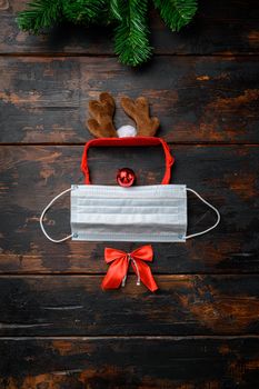 Minimal Christmas Concept Merry And Safe set and deer, on old dark wooden table background, top view flat lay
