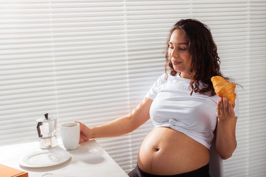 Pregnant woman eating breakfast. Pregnancy and maternity leave.