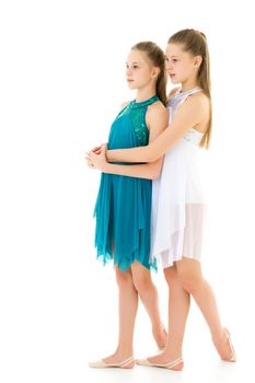 Pretty Gymnasts Performing Rhythmic Gymnastics Exercise, Two Beautiful Teen Sisters Dancing Wearing Sport Dresses, Two Girls Posing in Studio Against White Background