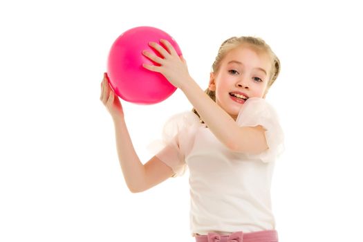 A charming little girl is engaged in fitness with a ball. The concept of gymnastics, health and sports. Isolated on white background.