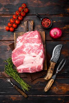 Pork Neck meat steak set, with ingredients and herbs, on old dark wooden table background, top view flat lay