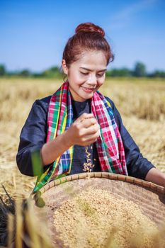 paddy rice in happy farmer woman hand