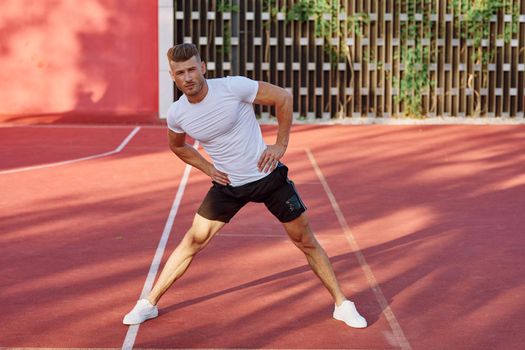 man on the sports ground exercise warm-up lifestyle. High quality photo