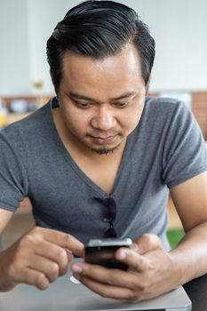 young man using smartphone in a cafe