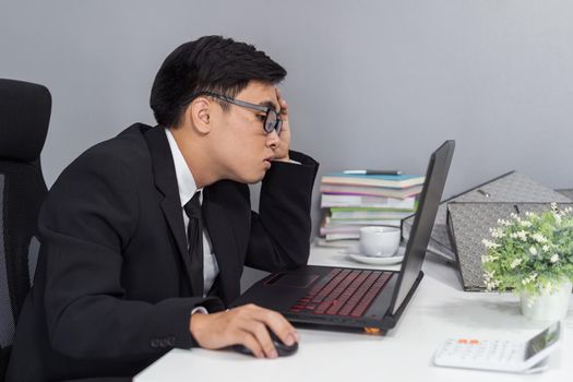 young business man working problem using laptop